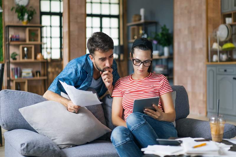 A couple on a sofa reviews their debts together.