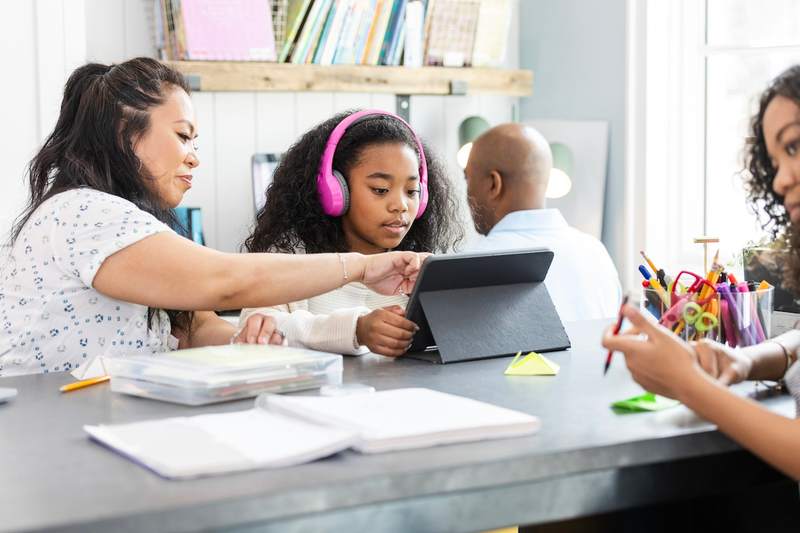 Teacher in classroom helping student