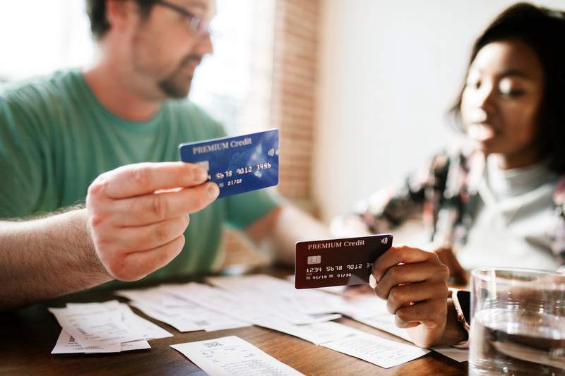 A couple discusses ways to pay their credit card debts.