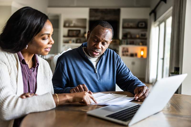 man and woman reviewing finances while discussion mortgage options